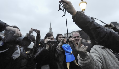 A protester holds up a doll depicting Margaret Thatcher during an event marking the death of the late Prime Minister at the Trafalgar square in London