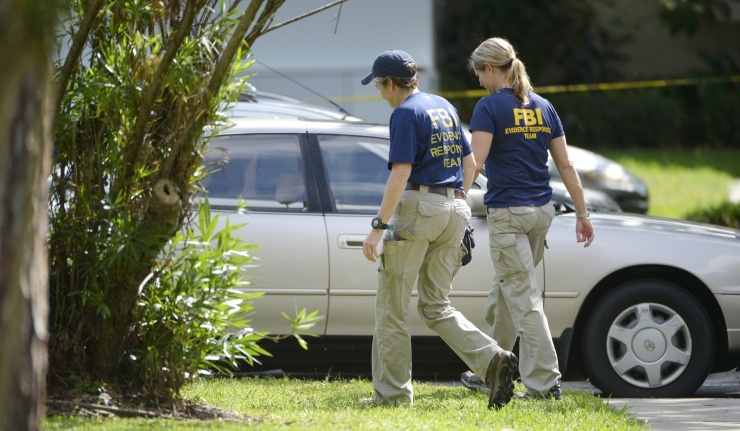 FBI personnel walk through the complex surrounding the apartment, where Ibragim Todashev, 27, was shot and killed by FBI